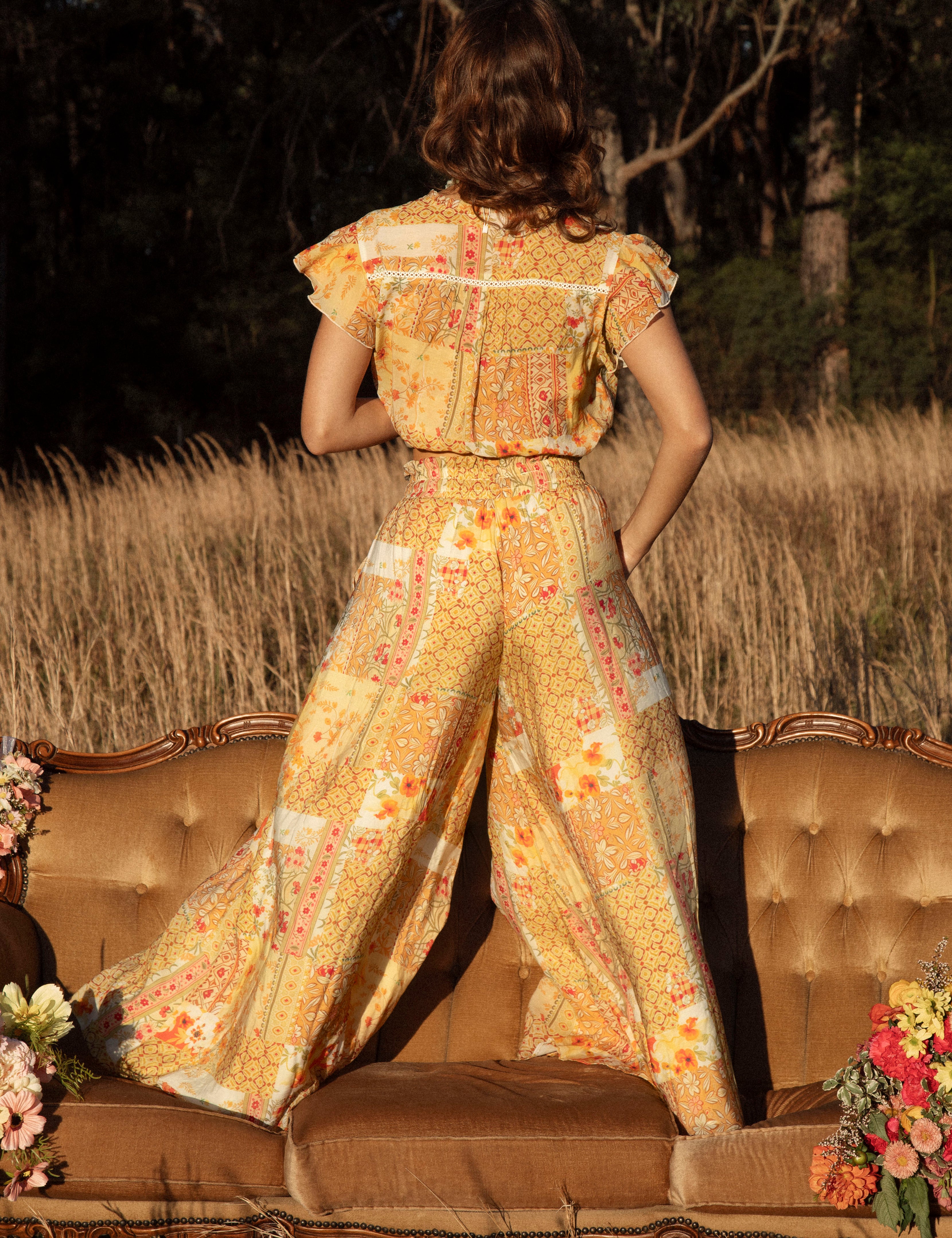 Resort Pant Fields of Gold - rear view showcasing vintage-inspired floral pattern in shades of yellow, brown and orange.
