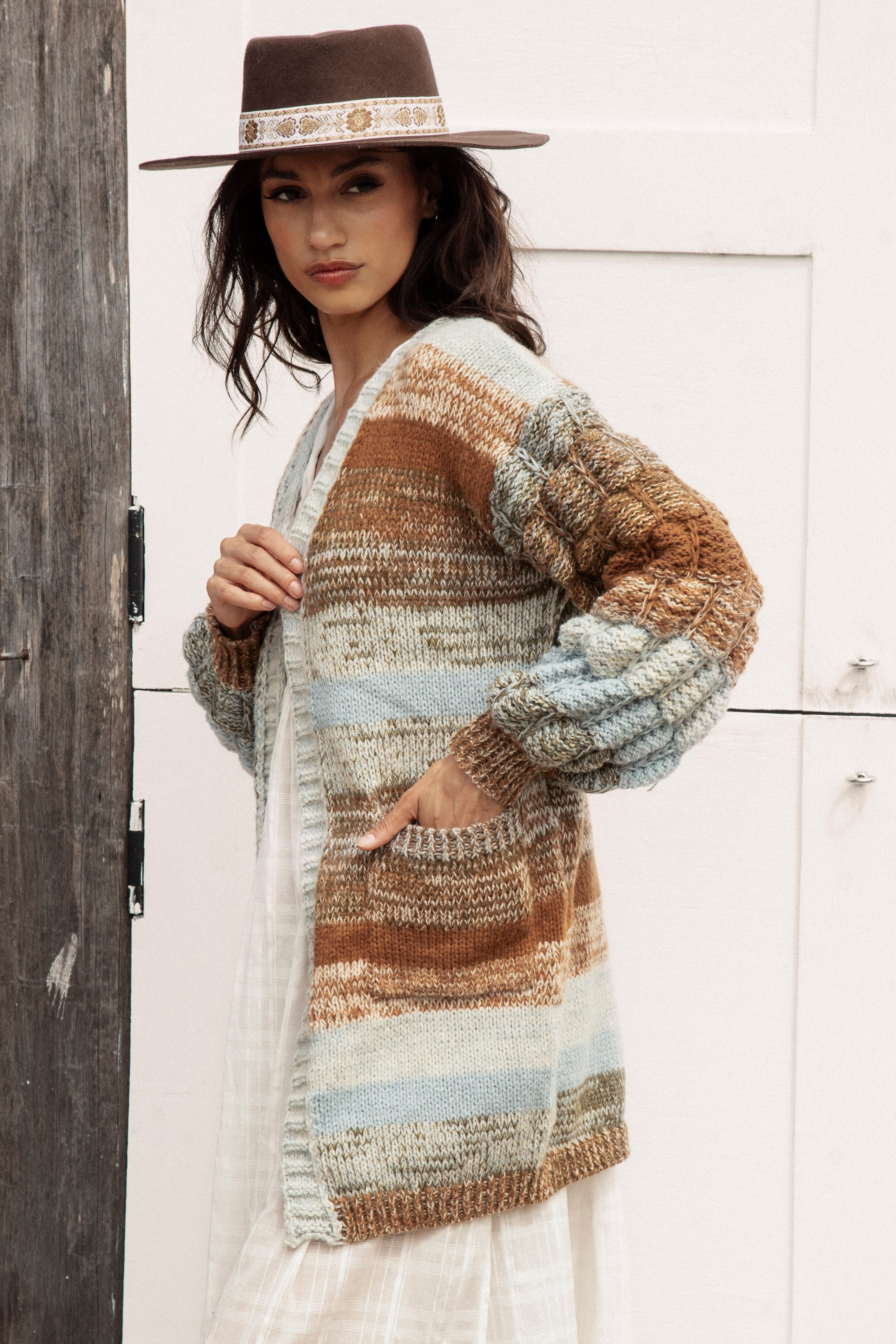Riverbend Stripe Cardi featuring pockets and chunky knit at sleeves. ombré striped pattern in shades of pale blue, tan, brown and cream.