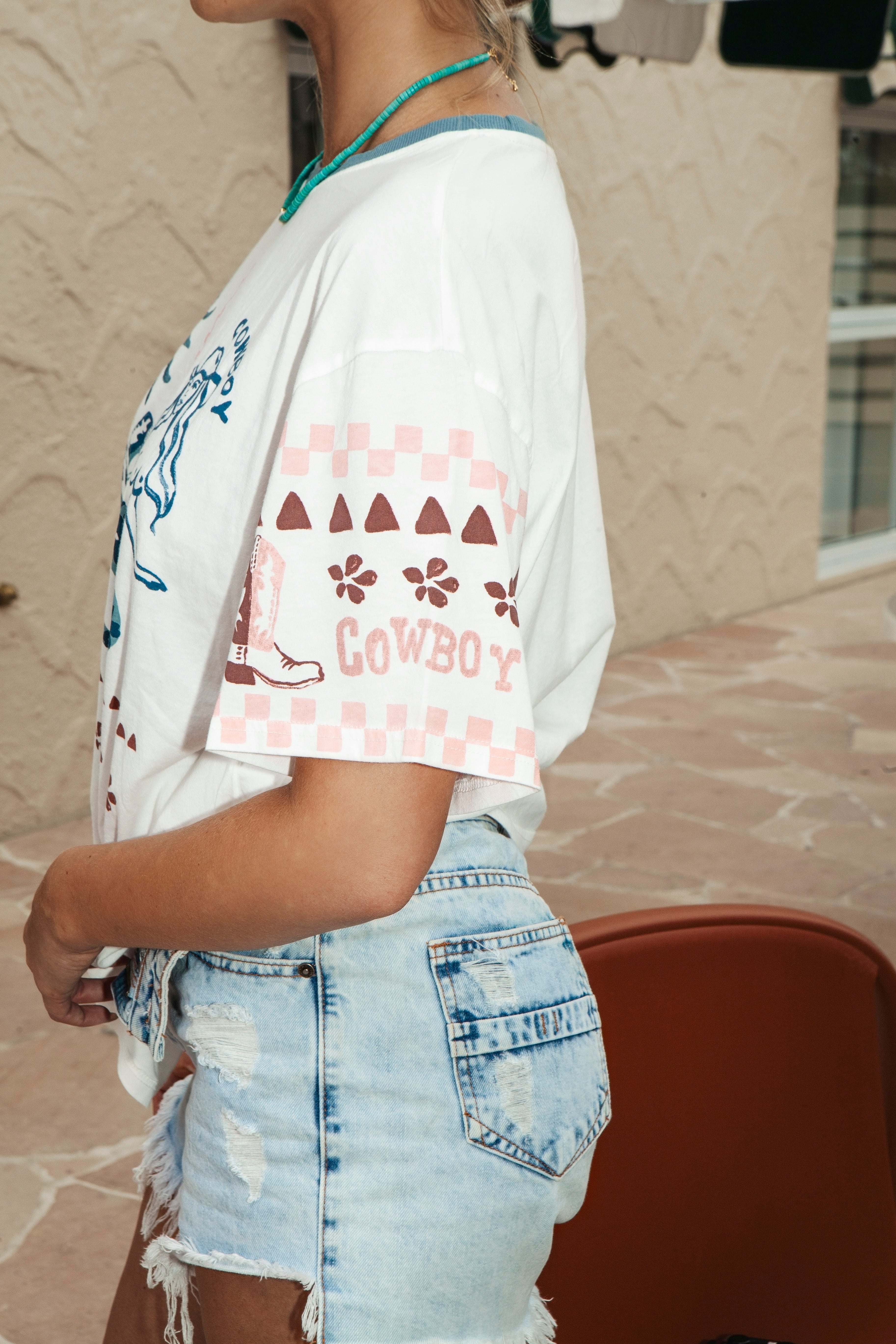 Rodeo Mermaid Tee - close up of cowboy motif on sleeve