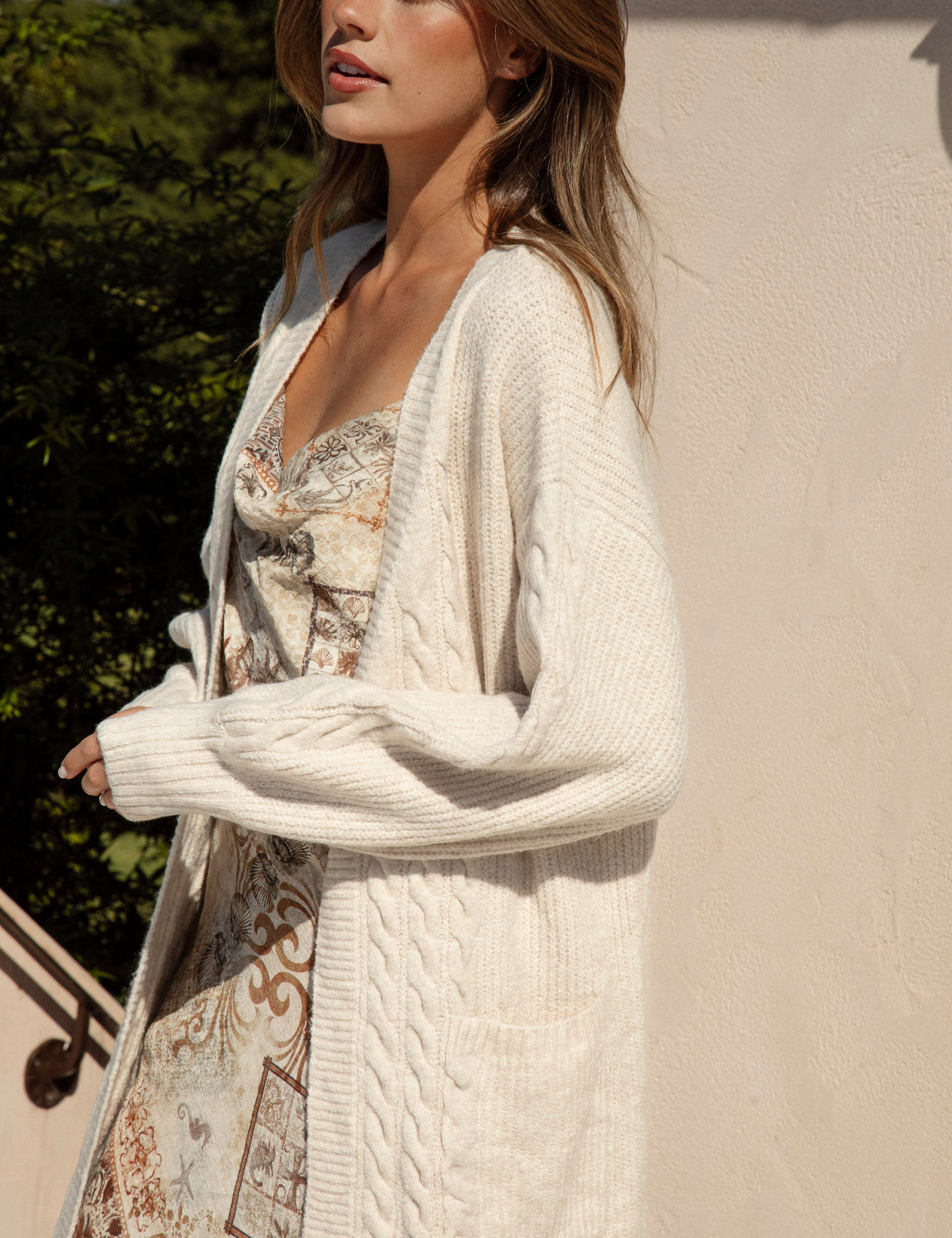 Romie Cable Cardigan Latte. Longline cardigan with statement pockets in neutral cream colourway.