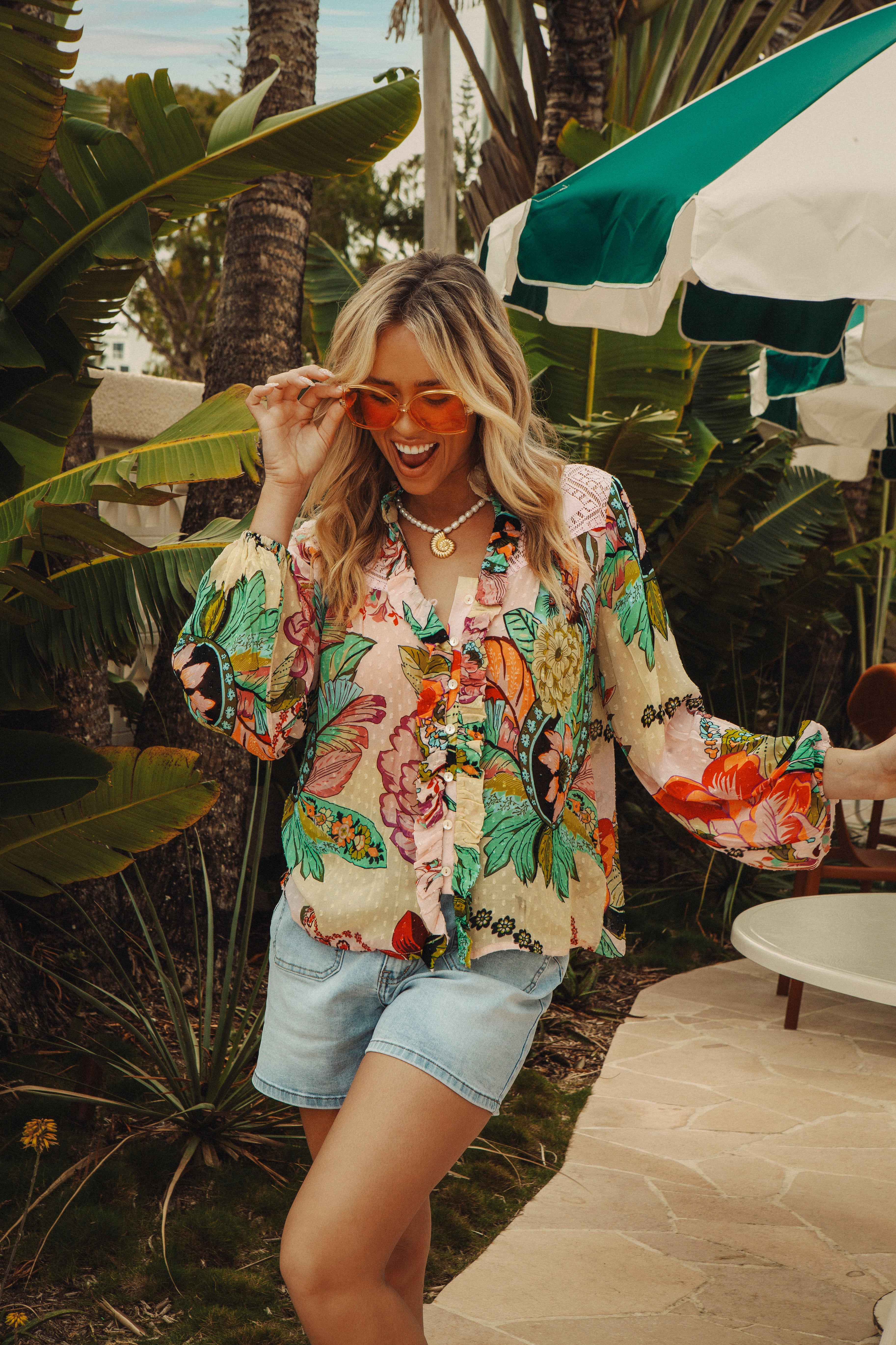 Rosé Blouse is a long sleeve blouse  featuring a bold floral print in shades of aqua and pink
