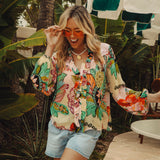 Rosé Blouse is a long sleeve blouse  featuring a bold floral print in shades of aqua and pink