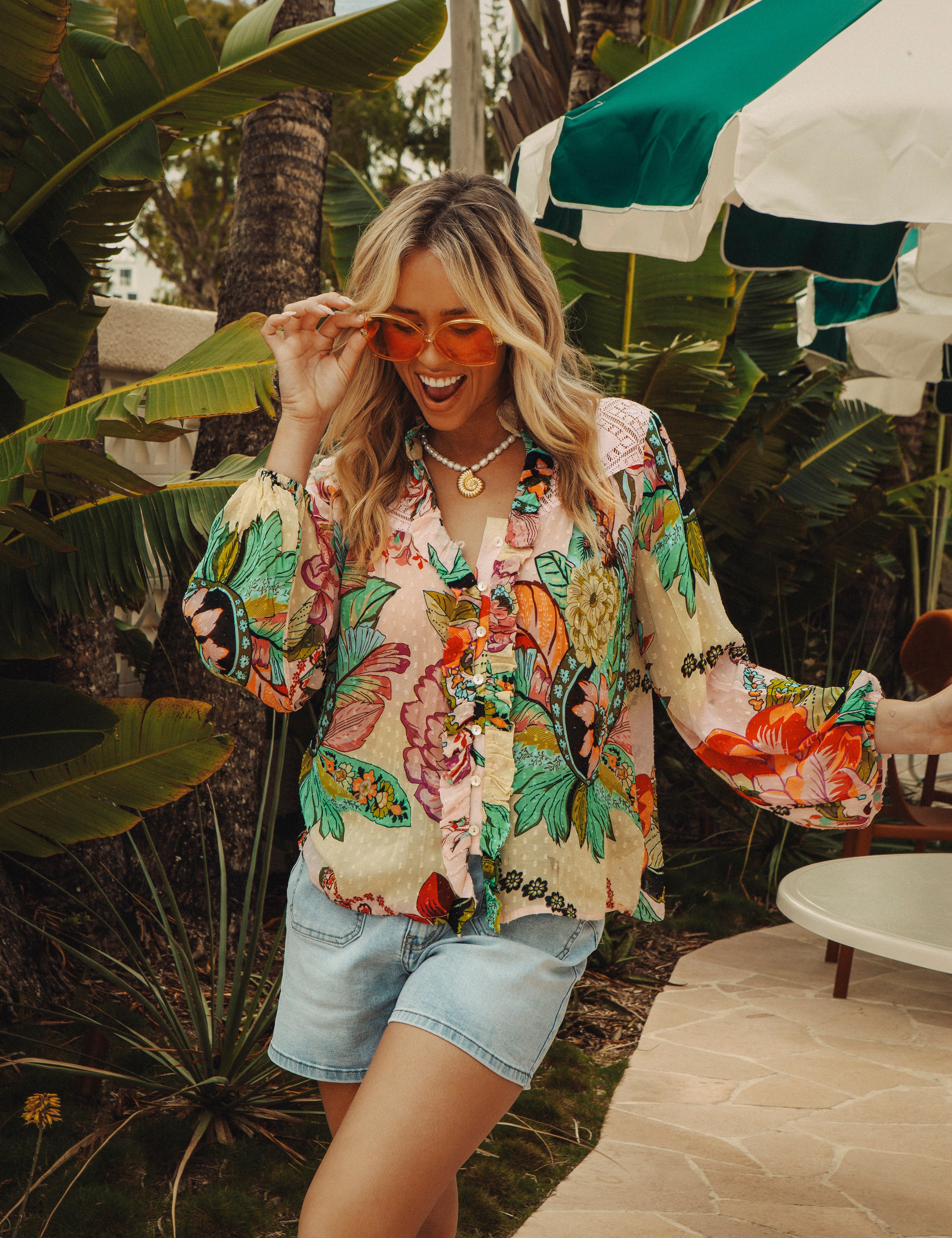 Rosé Blouse is a long sleeve blouse  featuring a bold floral print in shades of aqua and pink