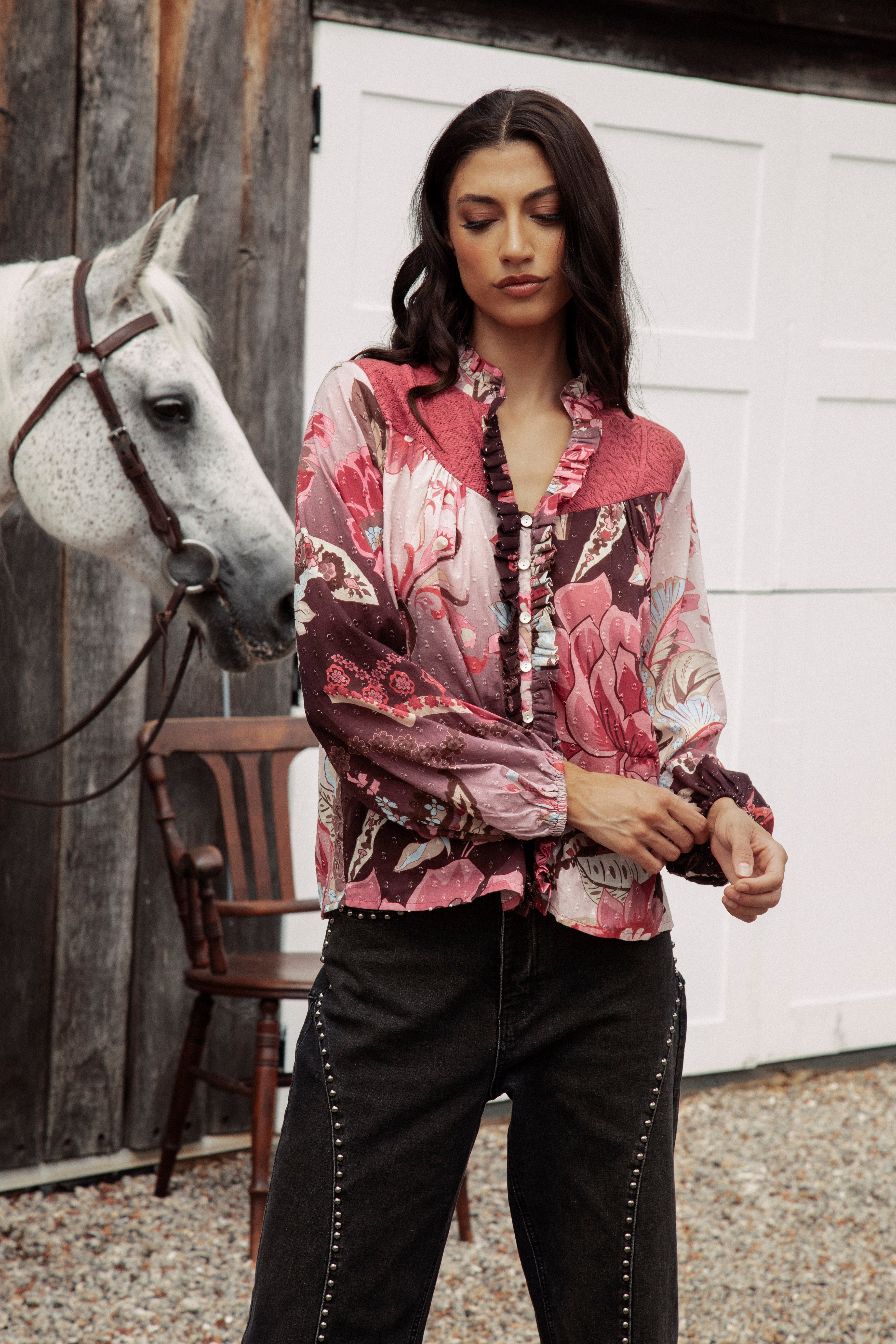 Rosé Blouse Merlot features long sleeves, button down style with ruffle detail.