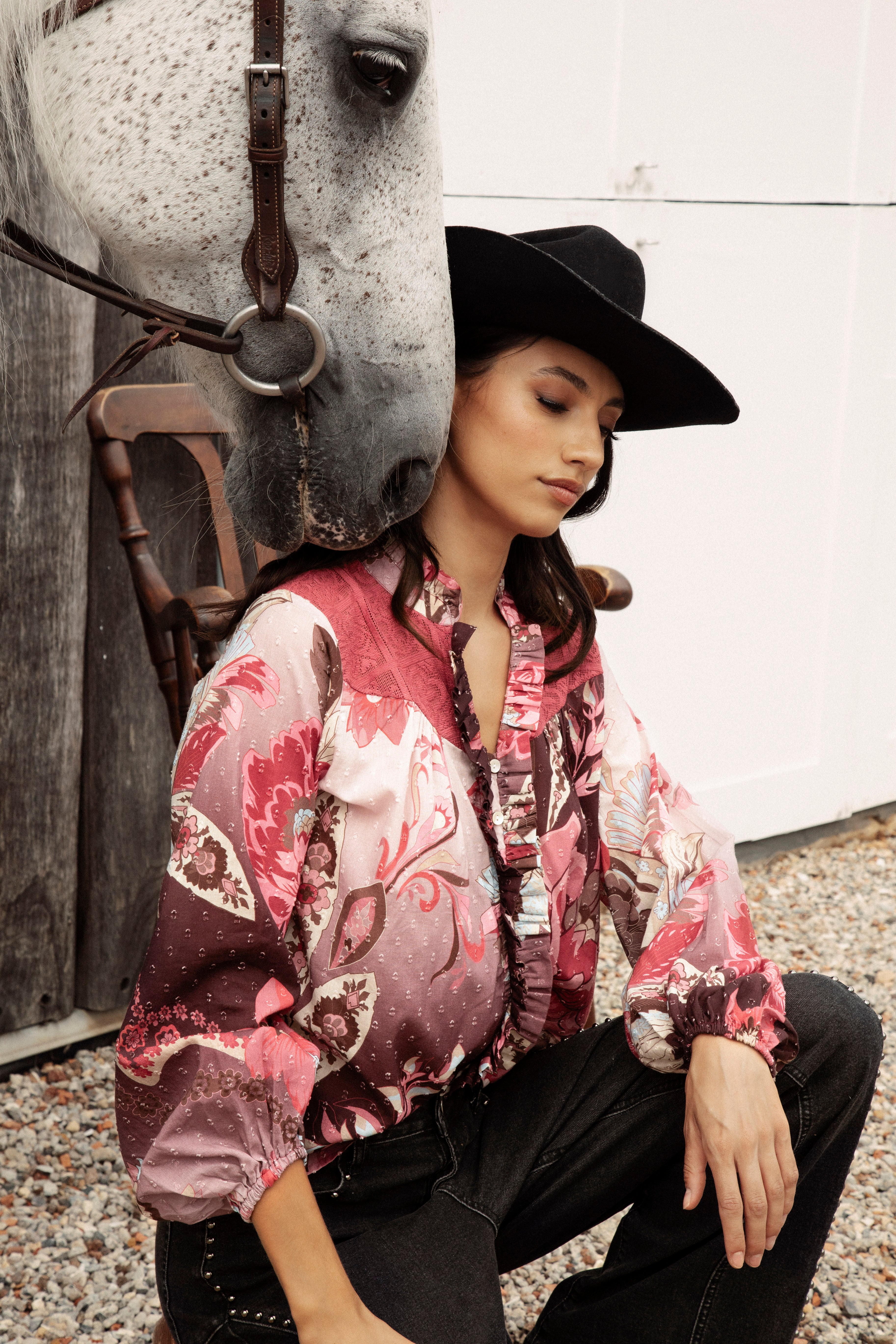 Rosé Blouse Merlot features long sleeves with elasticised cuff, button down style with ruffle detail and floral pattern in shades of pink, red and brown.