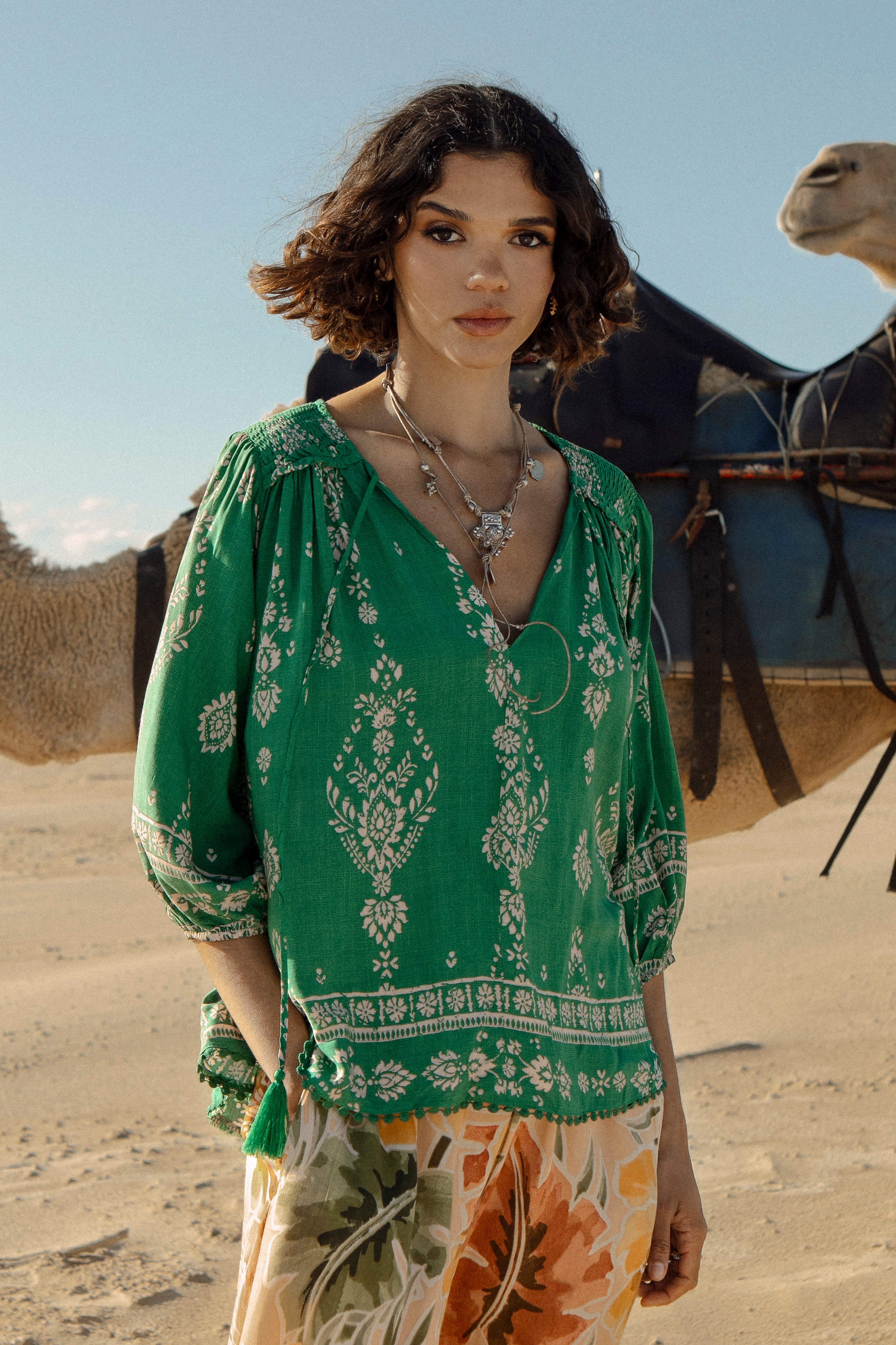 Rue Top Kiva Boho style top featuring 3/4 sleeves, v neck with tie closure, green colourway with contrasting pattern and trim