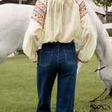 Ryder Denim Jean featuring mid blue wash and bootleg style. Rear view.