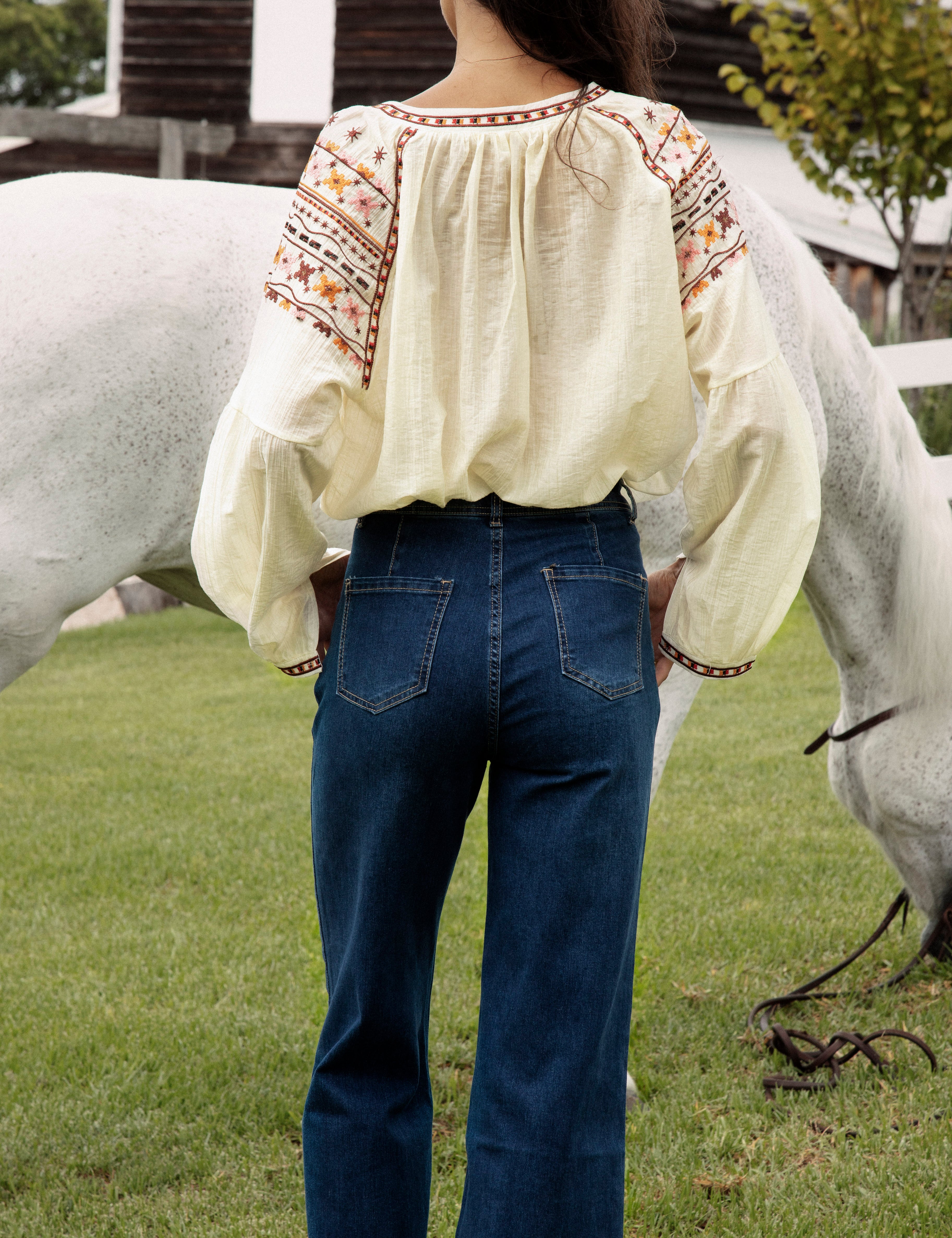 Ryder Denim Jean featuring mid blue wash and bootleg style. Rear view.