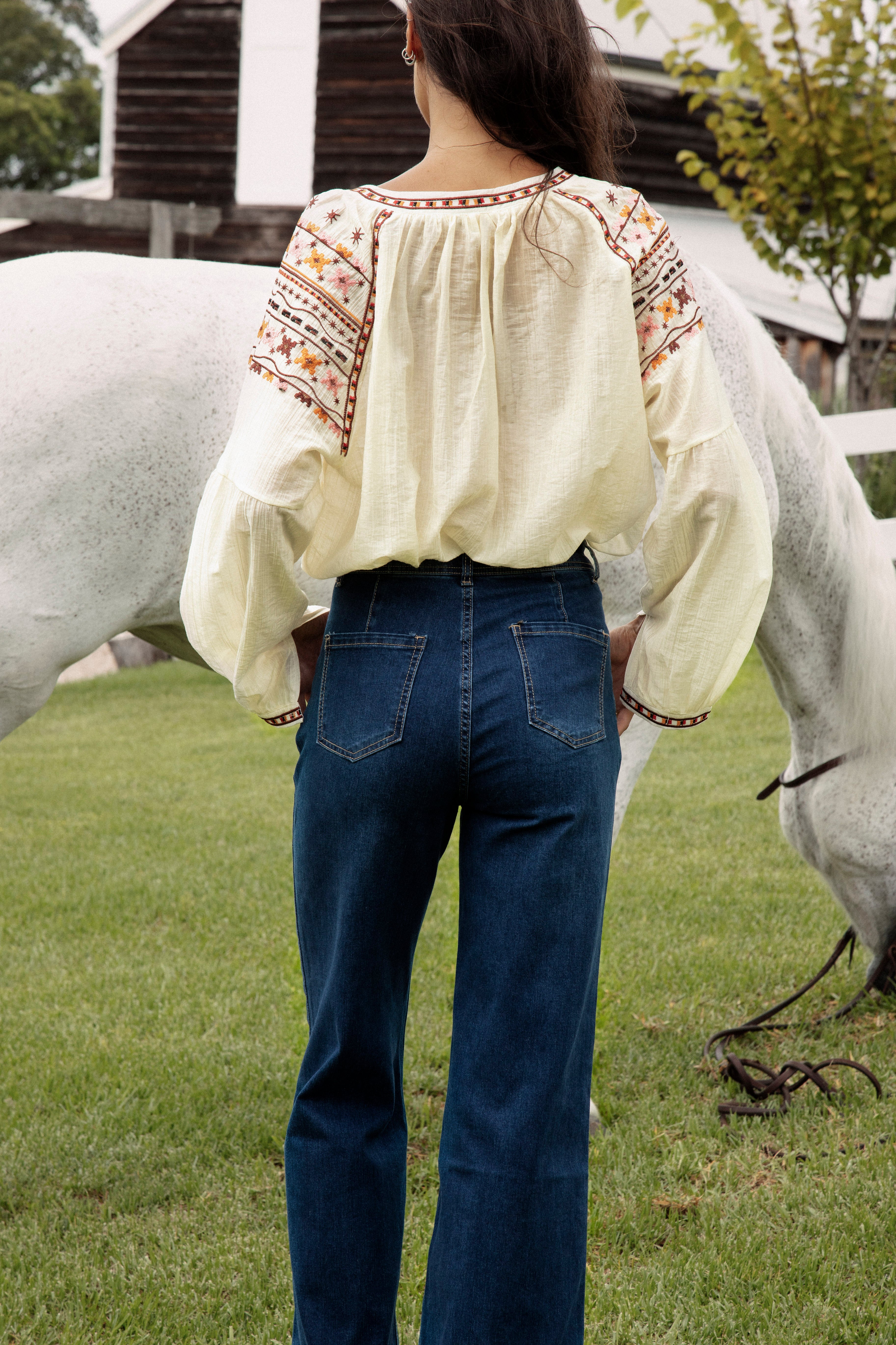 Ryder Denim Jean featuring mid blue wash and bootleg style. Rear view.