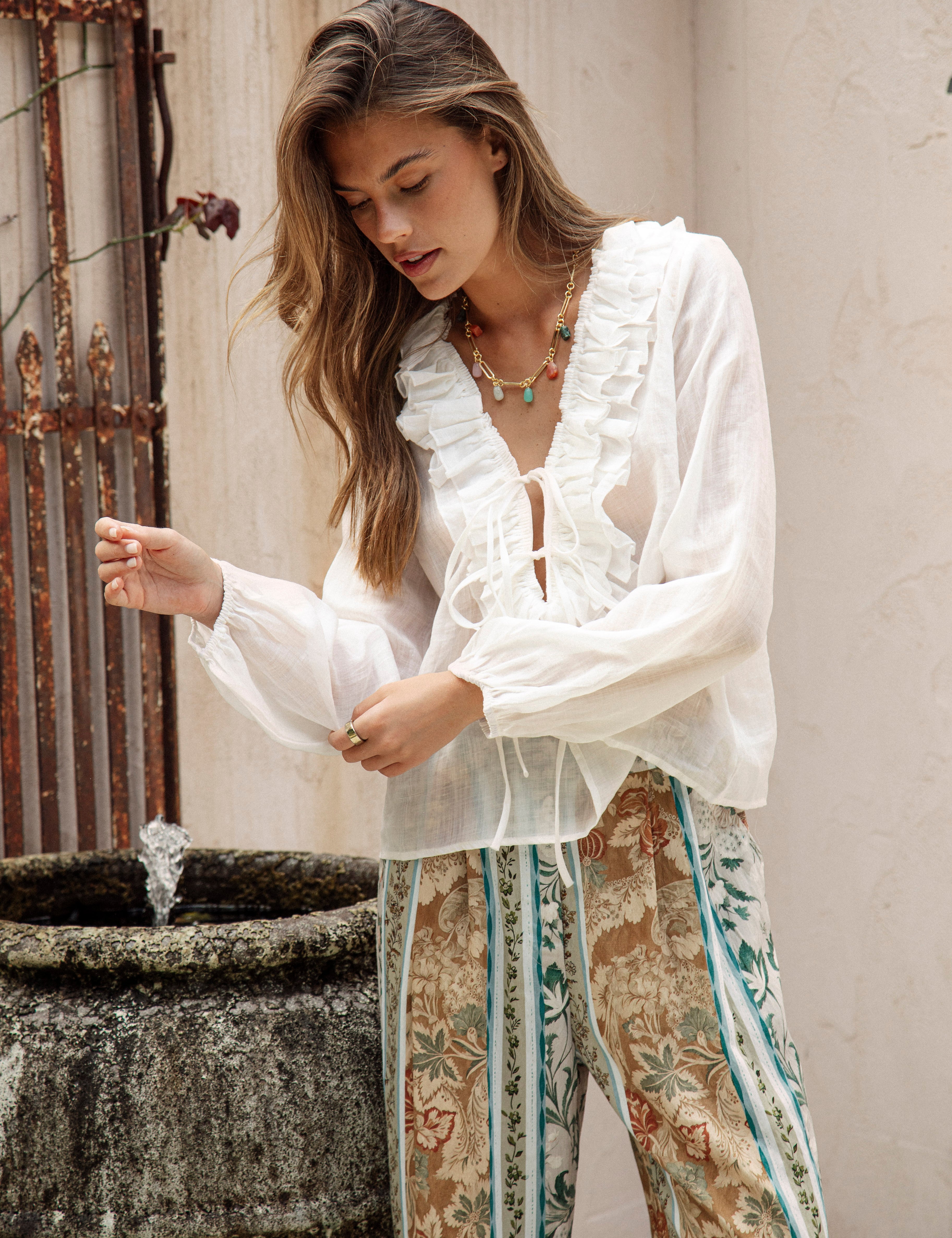 Sicilia Blouse features long sleeves with elasticised cuffs and ruffled detail at bodice