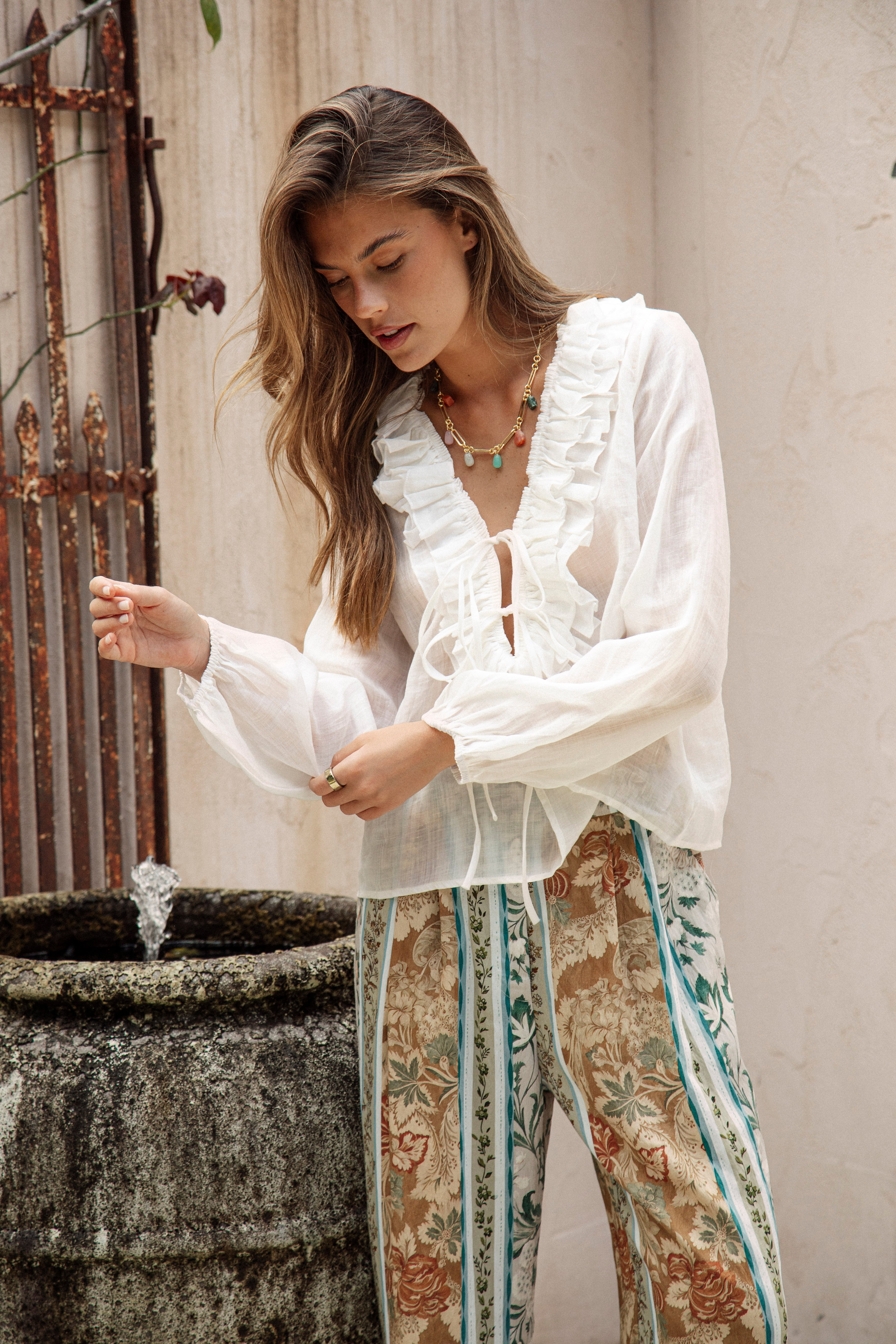 Sicilia Blouse features long sleeves with elasticised cuffs and ruffled detail at bodice