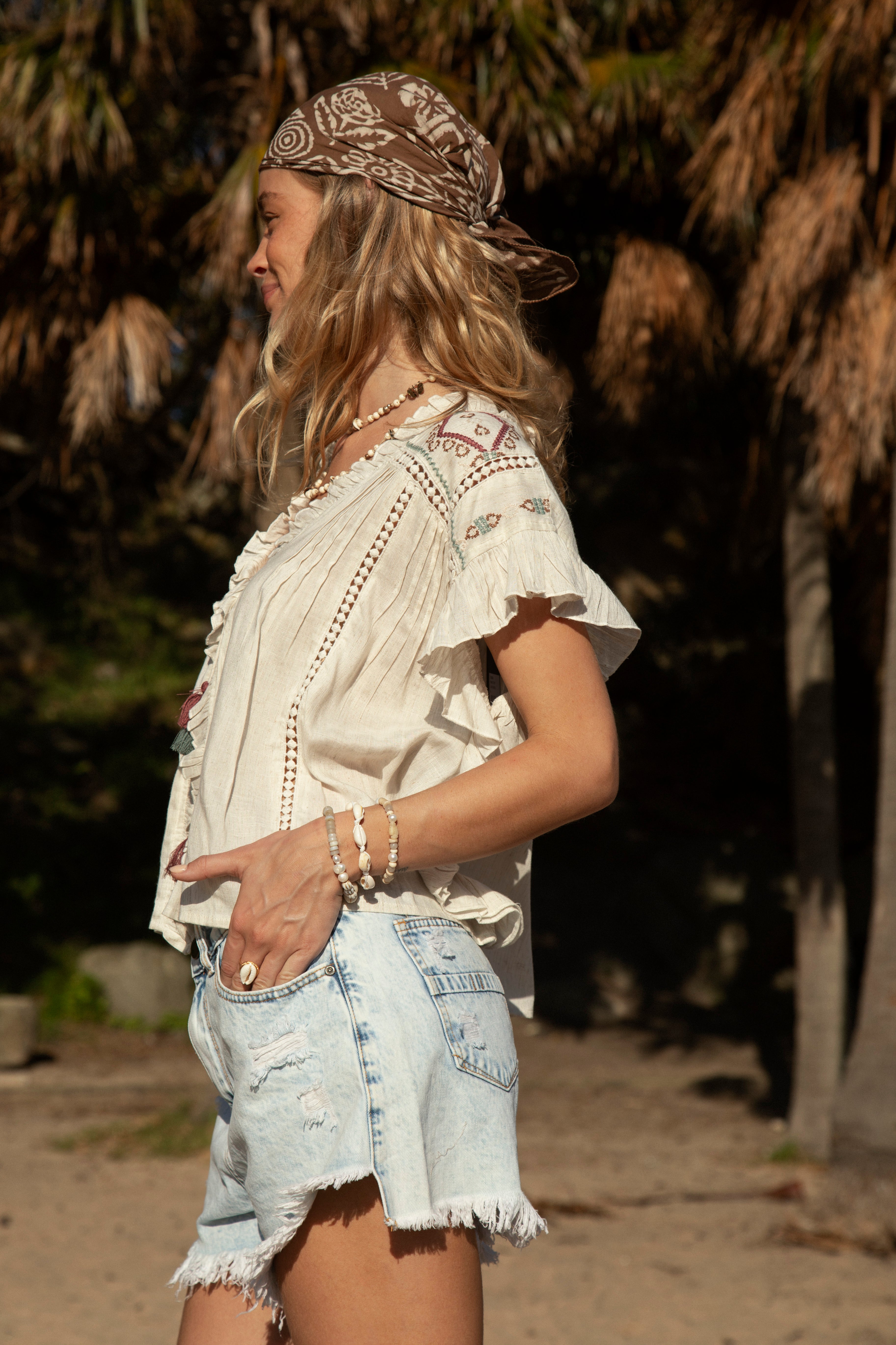 Stella Tie Top Shell features ruffle sleeves, Aztec style embroidery and tassel detail