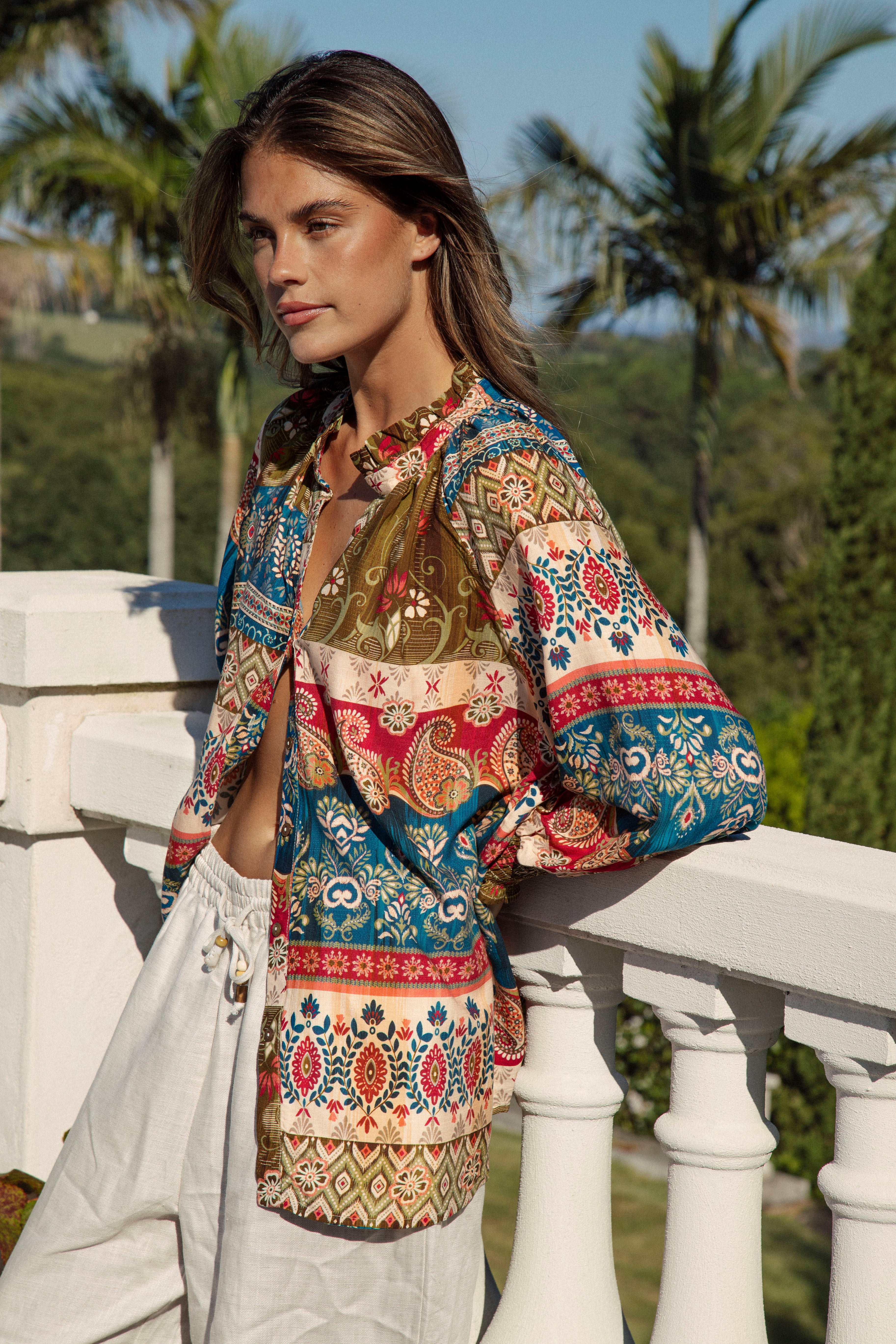 Sunkissed Blouse Olea featured stand collar and Bohemian print in shades of red, ivory, blue and gold