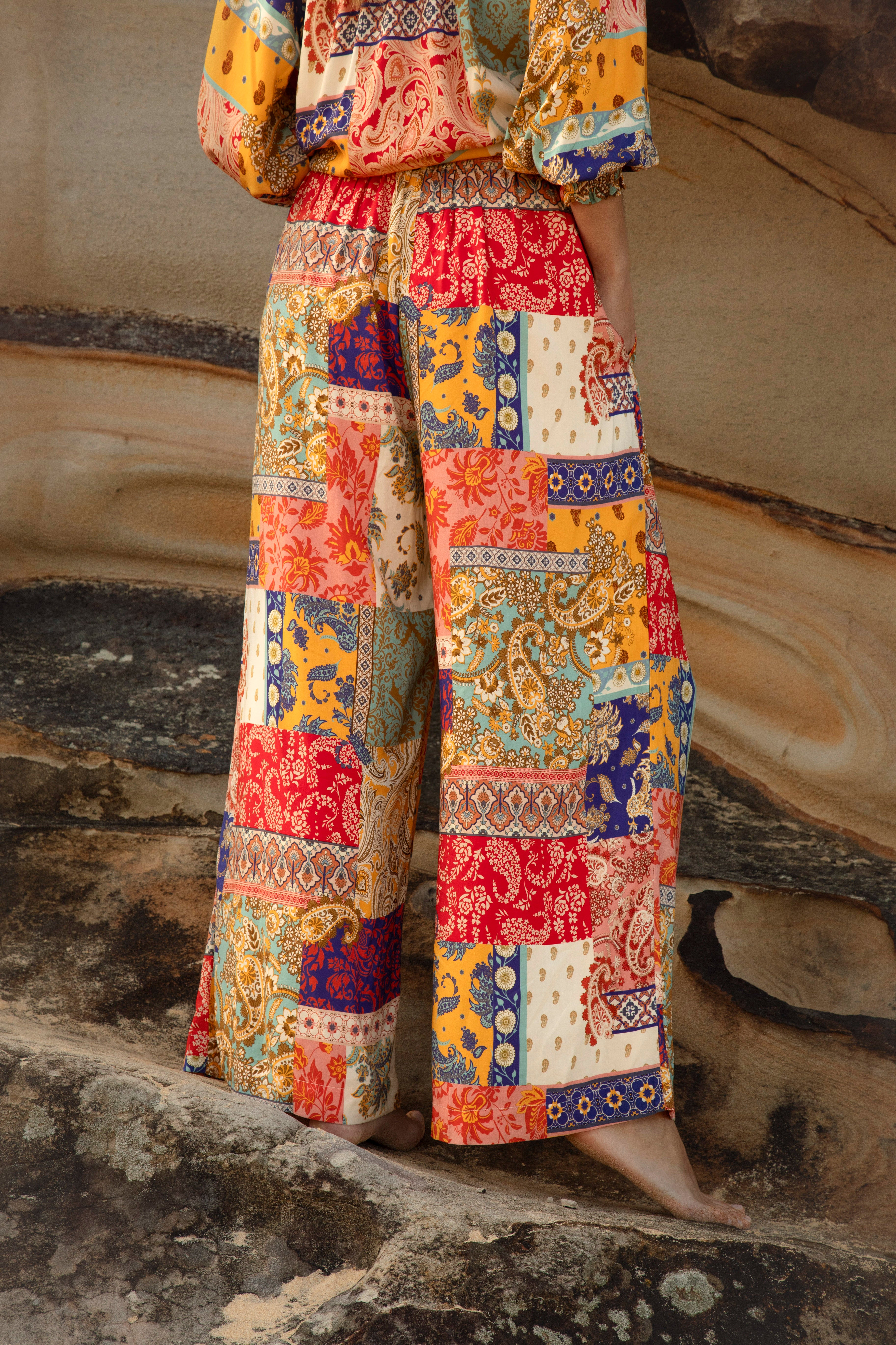 Sunseeker Pants feature a boho inspired patchwork pattern in vibrant colourway. Rear View.