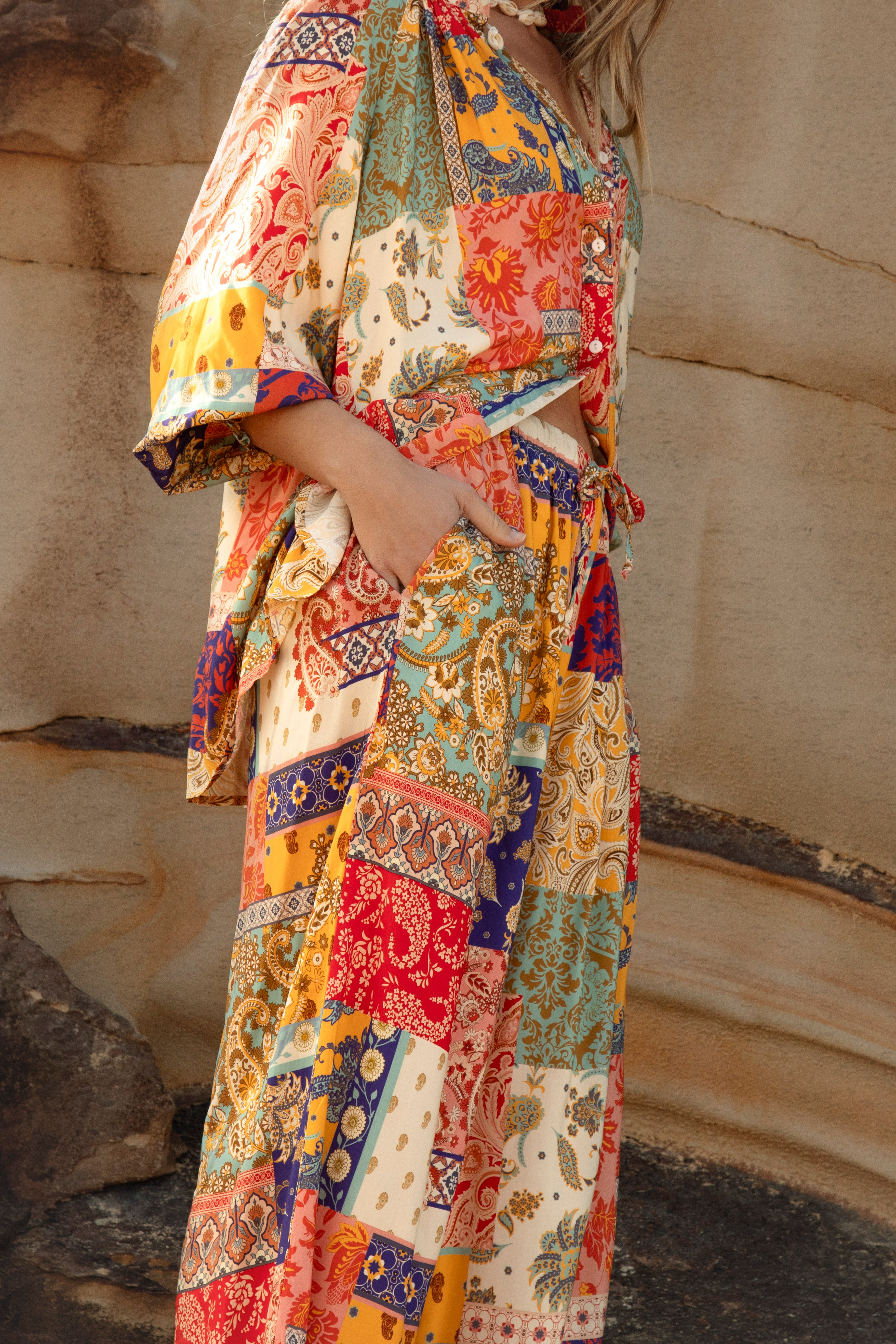 Sunseeker Pants in vibrant patchwork pattern with front pockets and relaxed elasticised waistband with drawstring closure.