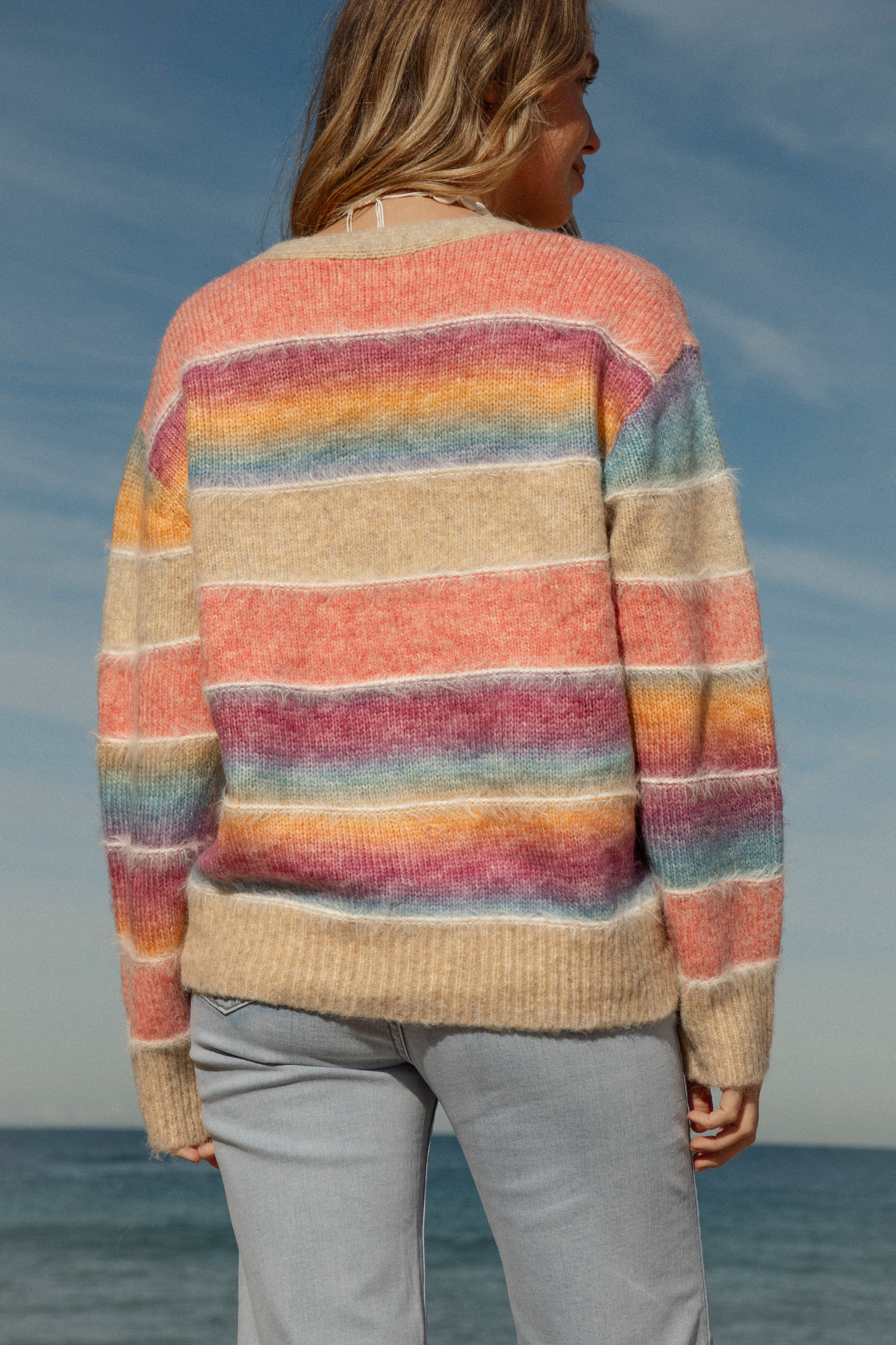 Sunshine State of Mind Cardigan is a Boho style rainbow striped cardigan. Rear View.