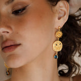 The Collectors Trove Earrings - gold drop earring featuring tiered drop of golden discs and sapphire blue gems