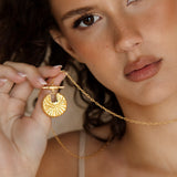 The Golden Compass Necklace - gold necklace on long chain with sun motif pendant