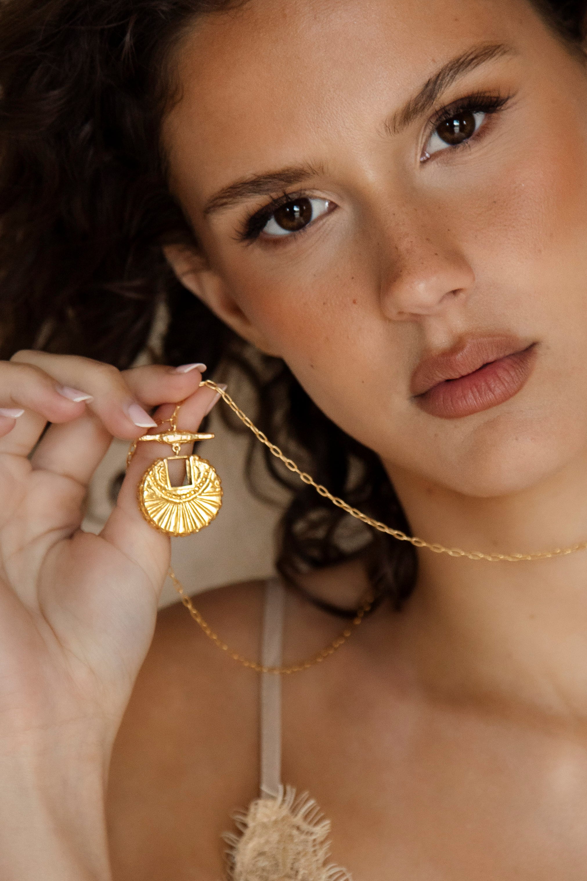 The Golden Compass Necklace - gold necklace on long chain with sun motif pendant