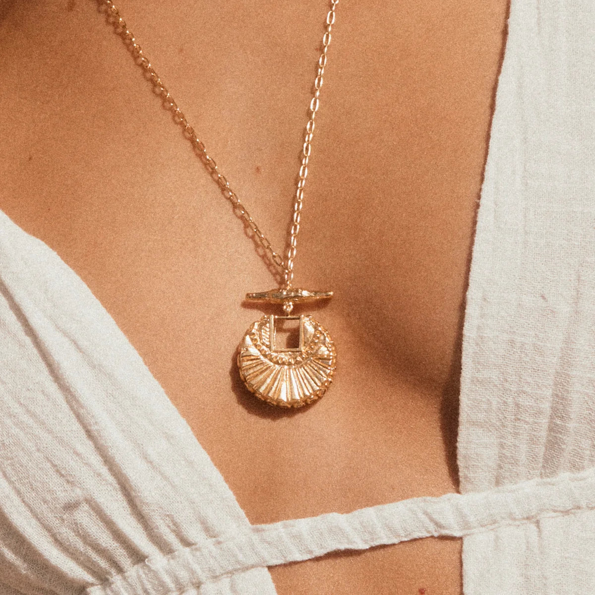 The Golden Compass Necklace - close up view of sun inspired pendant