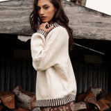 Tilly Knit Chocolate Stripe is a cream sweater with contrasting striped trim at neckline, hem and cuffs.