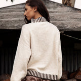 Tilly Knit Chocolate Stripe is a classic cream sweater with contrasting striped trim in brown tones.