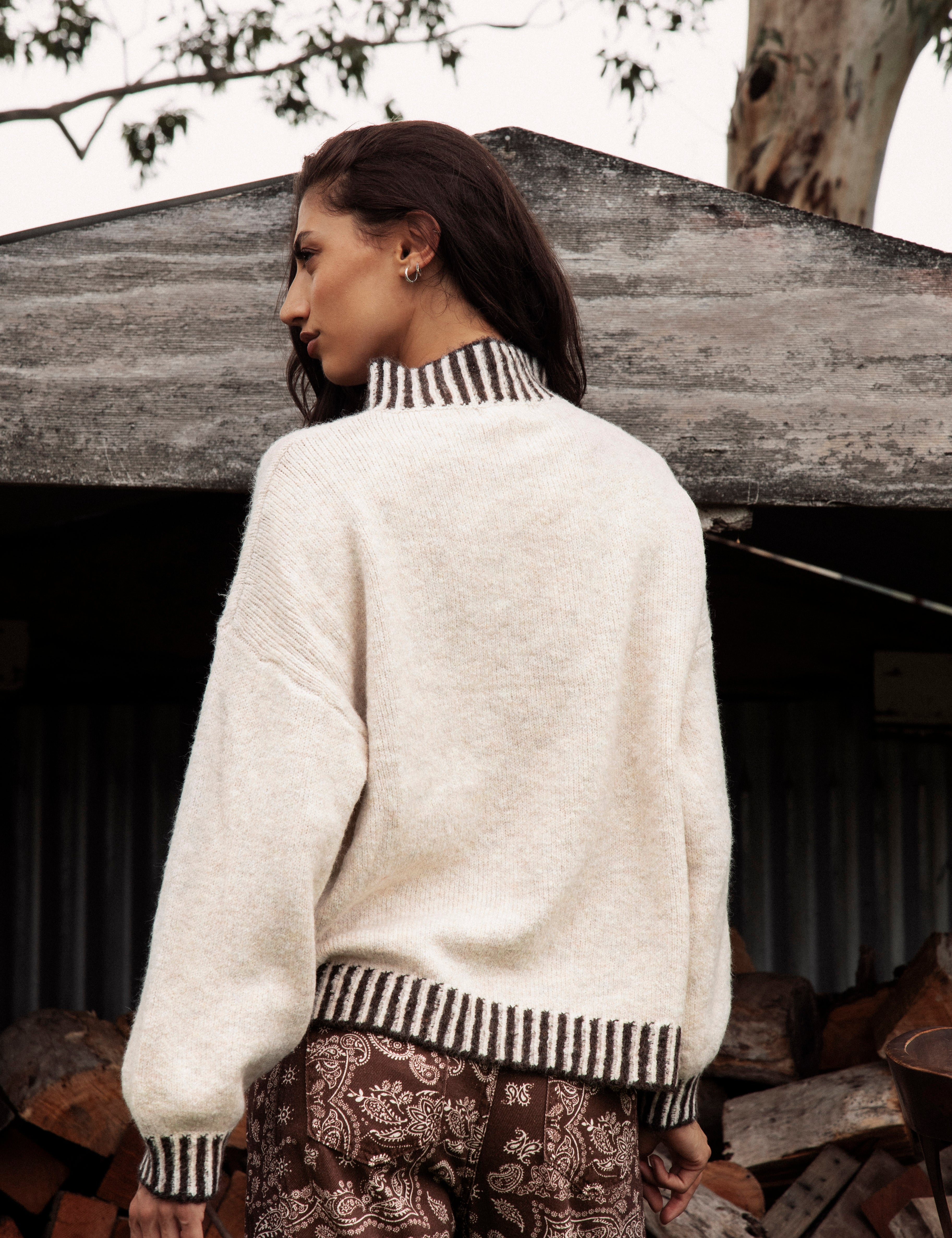 Tilly Knit Chocolate Stripe is a classic cream sweater with contrasting striped trim in brown tones.