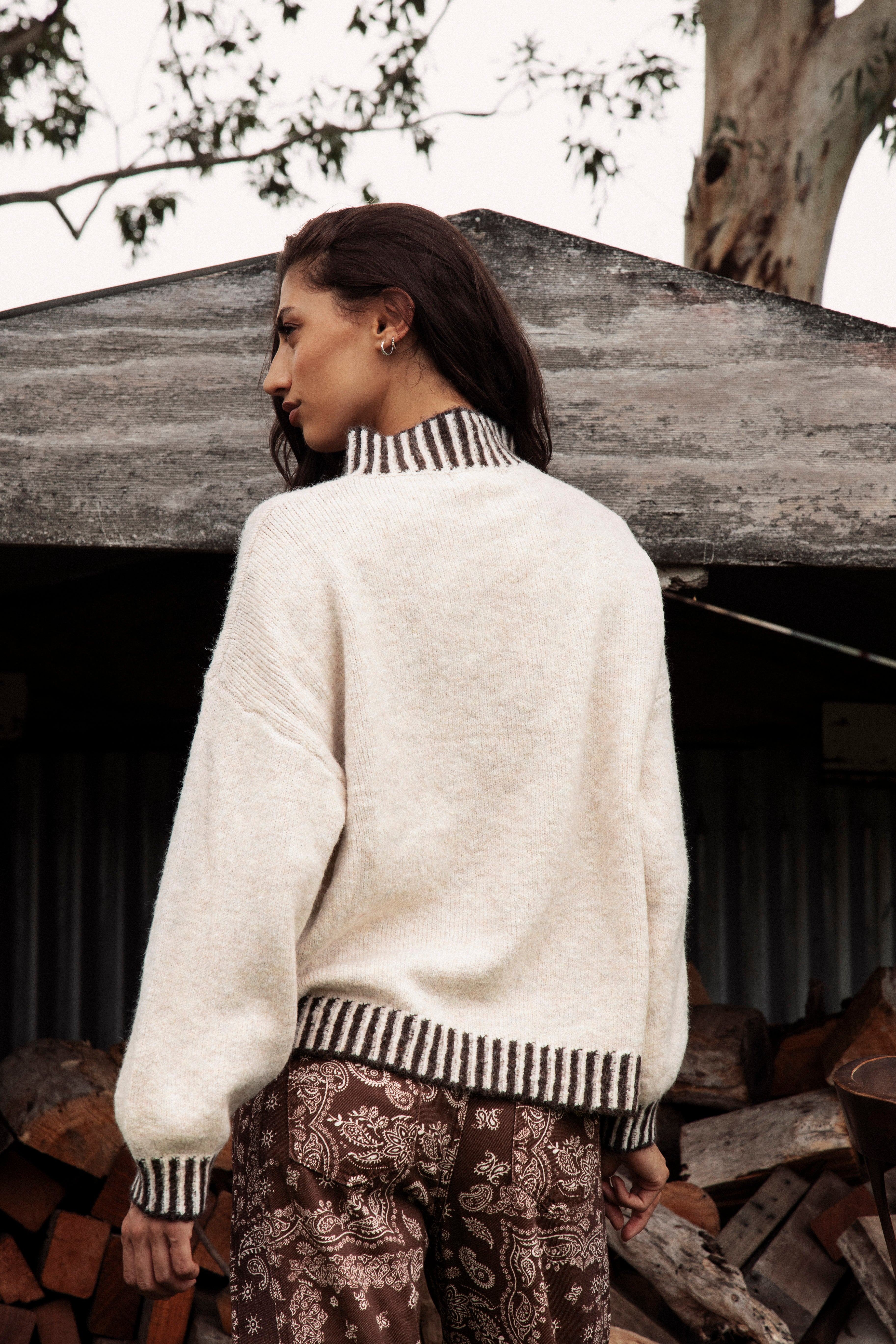 Tilly Knit Chocolate Stripe is a classic cream sweater with contrasting striped trim in brown tones.