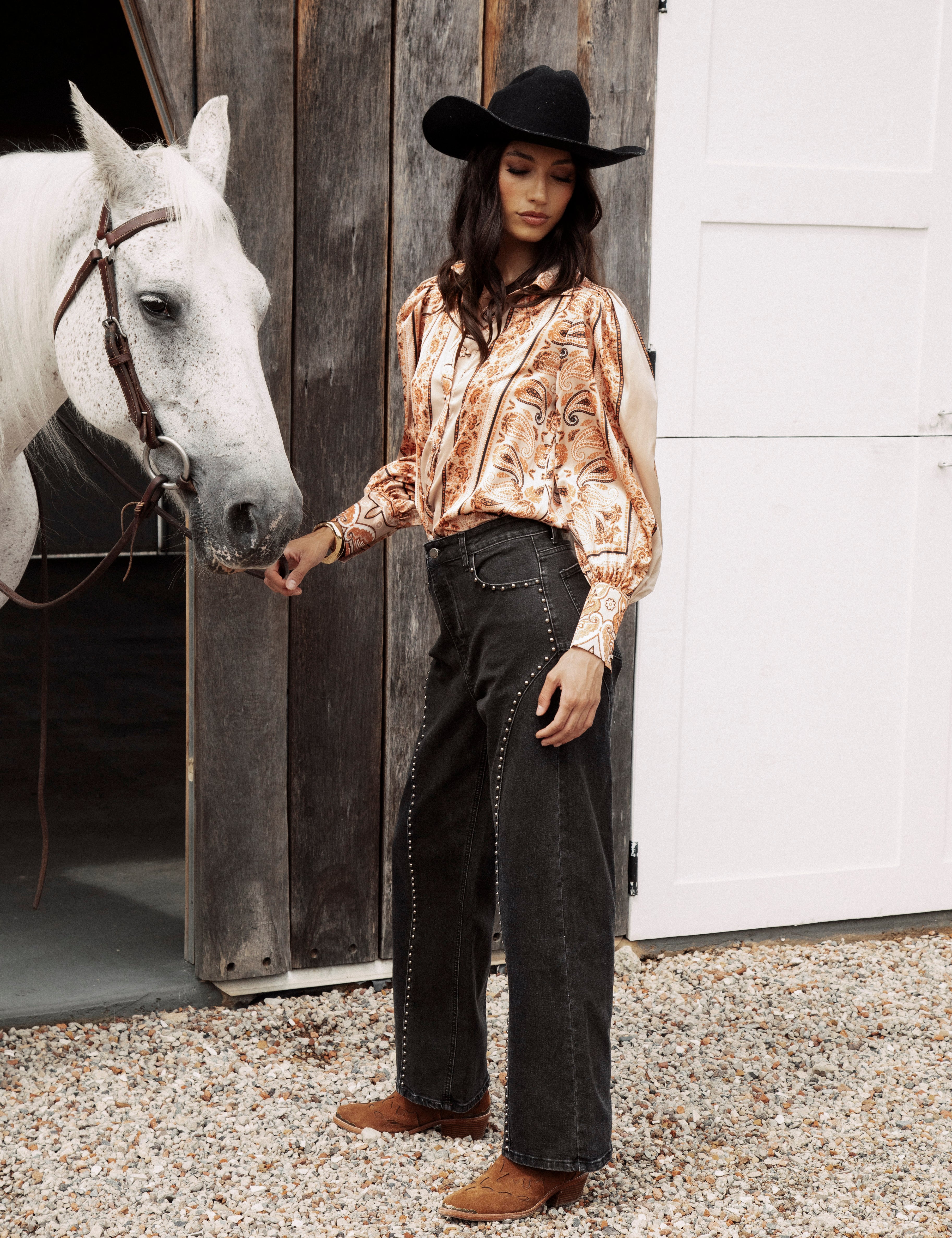 Wild Soul Studded Jean is a black denim jean featuring statement studs down legs