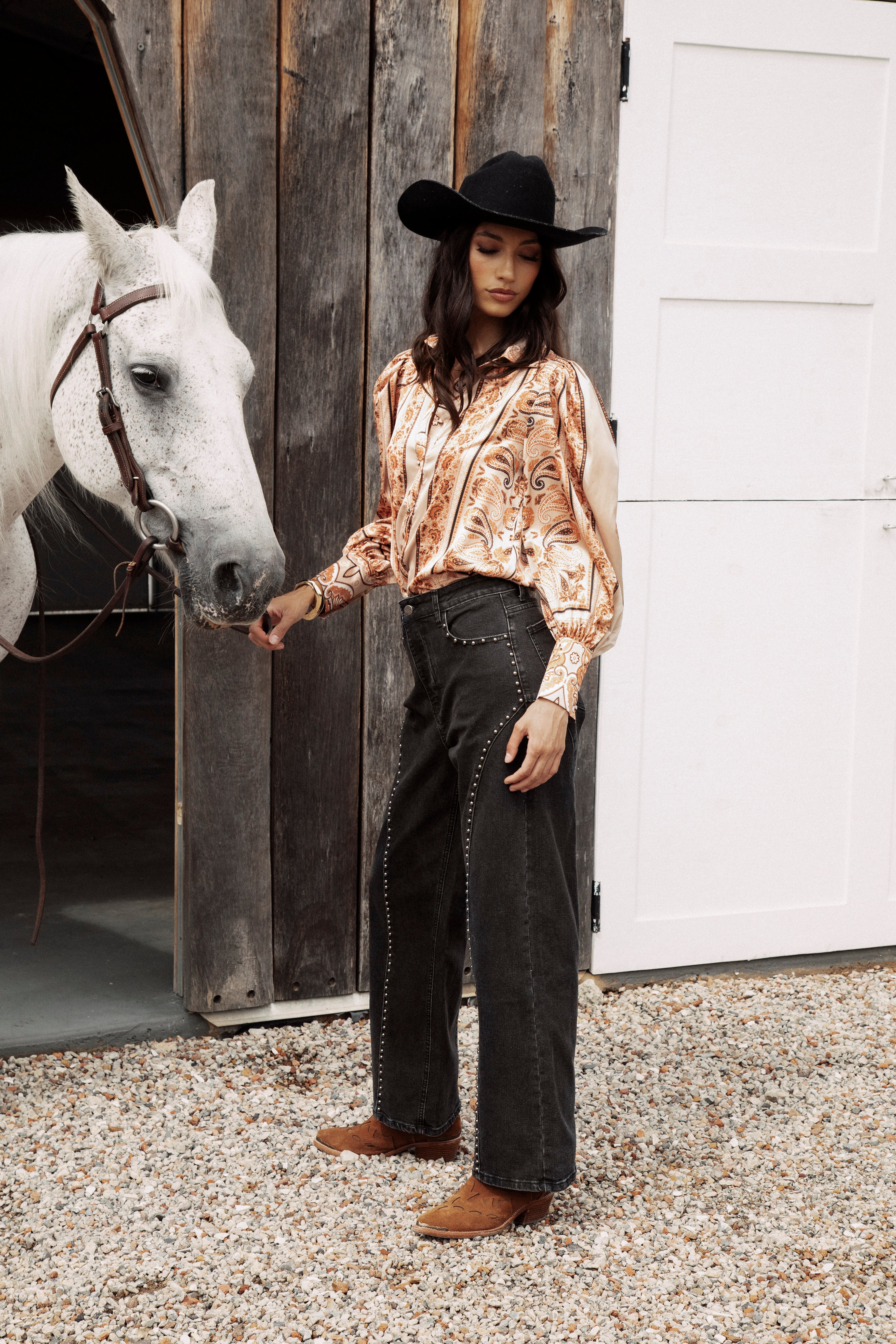 Wild Soul Studded Jean is a black denim jean featuring statement studs down legs