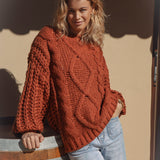 Wildwood Sweater in Ember features a beautiful rust colourway and chunky cable knit