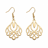 Gold earrings with intricate designs on a white background